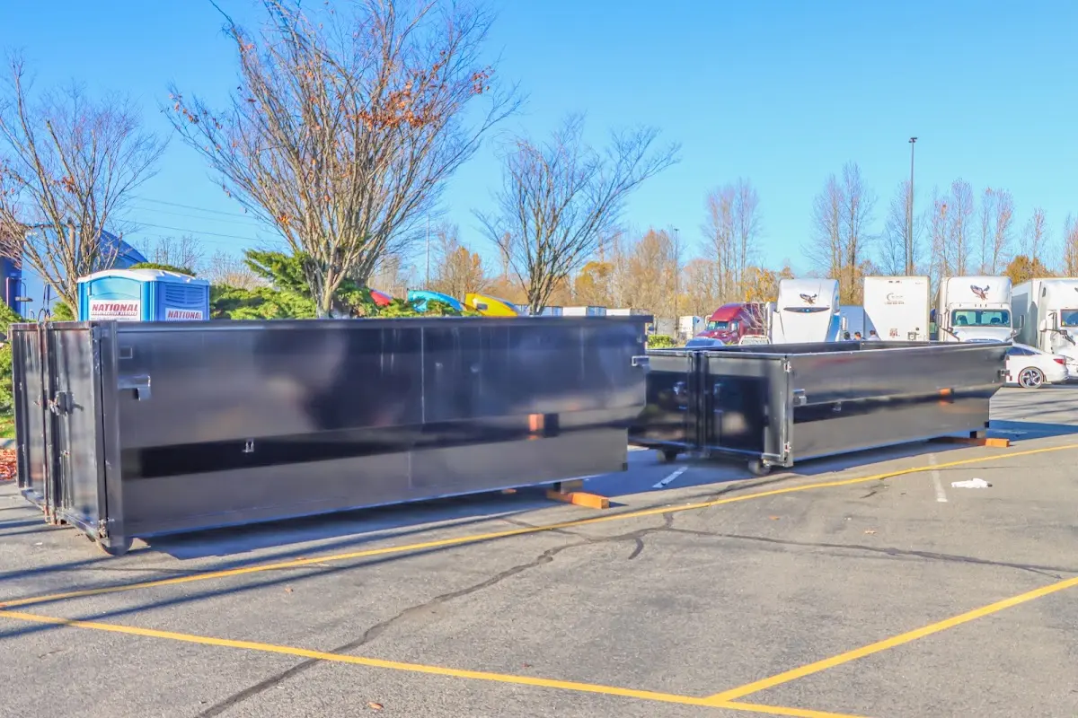 Professional dumpster rental service with roll-off container on residential driveway in Gloucester Point